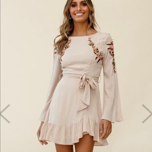 Dusty pink/blush dress with flower appliqué from Selfie Leslie Boutique.